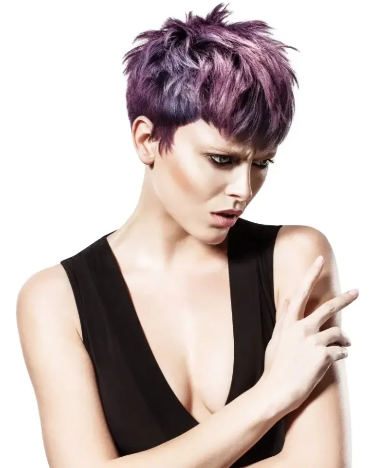 Model featuring a textured pixie cut with deep purple and violet hair color, wearing a V-neck black top