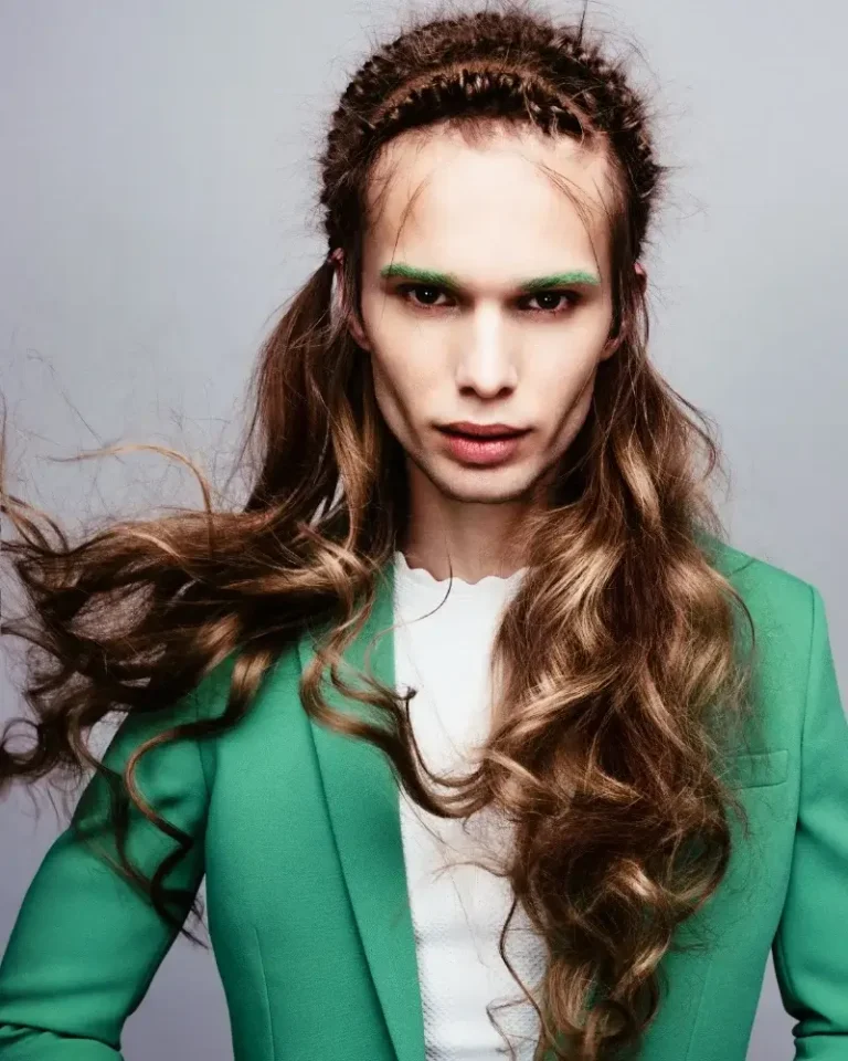 Model with long wavy brunette hair styled with two small braided accent rows running along the top of the crown