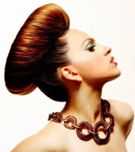 Profile shot of dramatic sculpted brown victory roll updo styled for Joseph Ferraro Hair BHA 2010